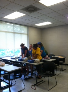 Field school students practicing  CPR.